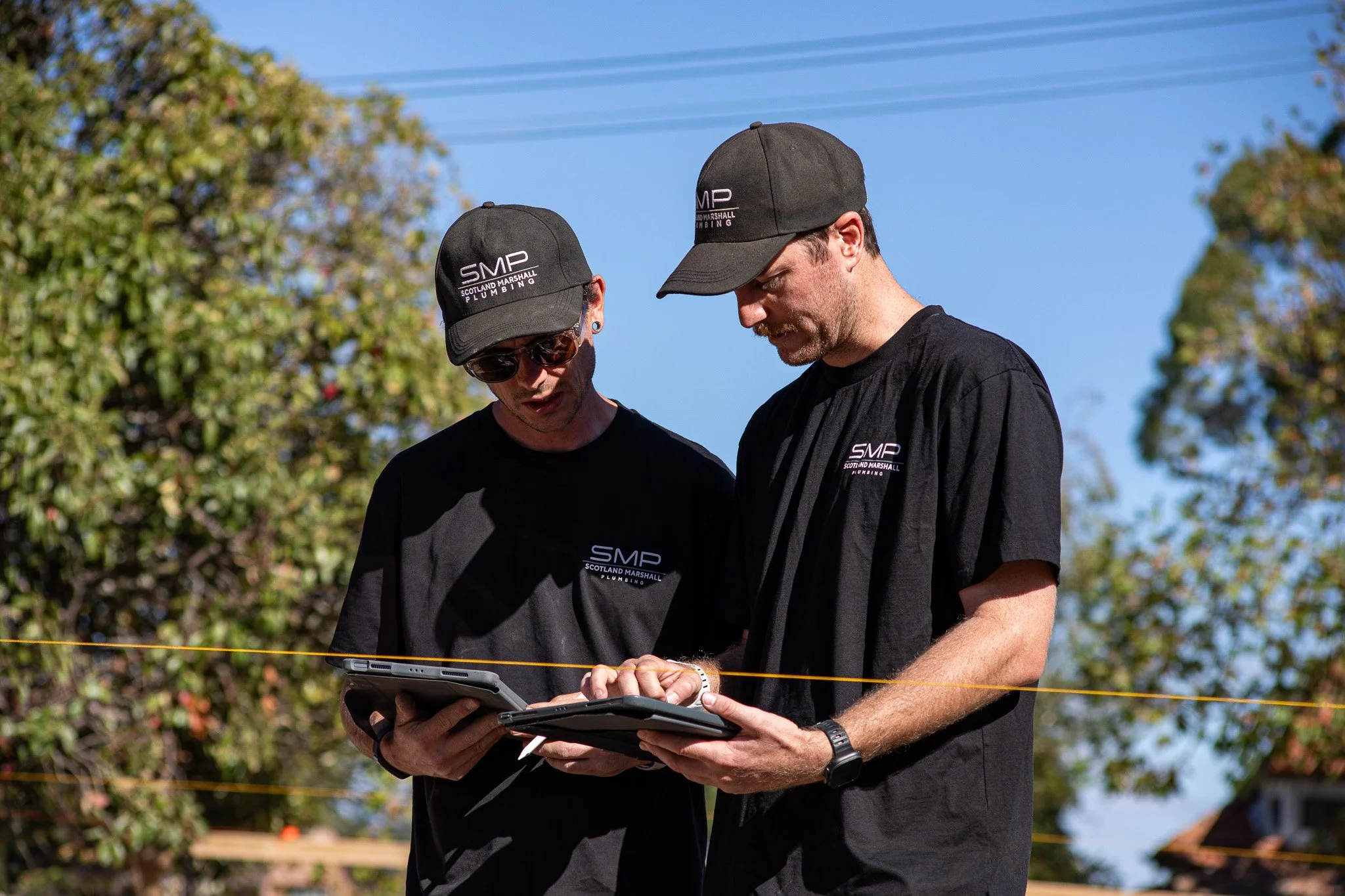 SMP plumbers checking drainage plans on site